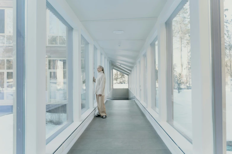 a man walking down a hallway in a building