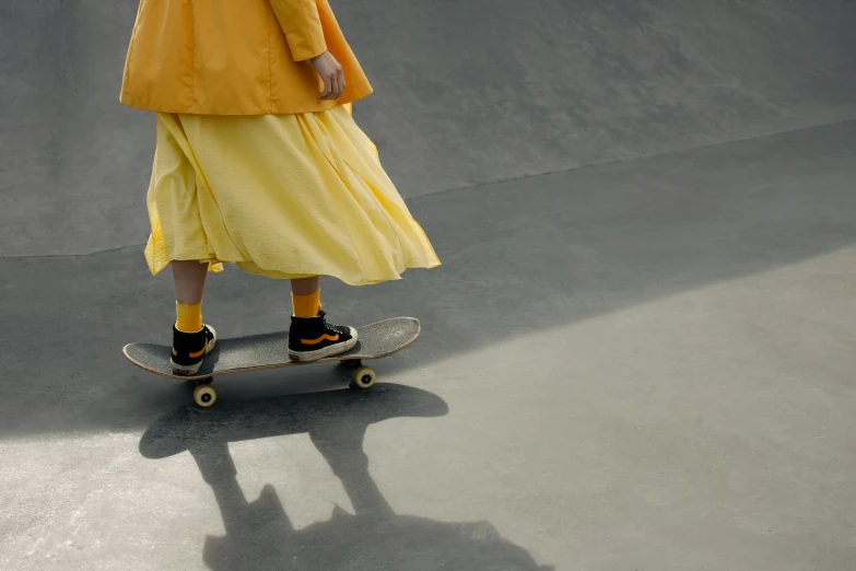 a girl riding on the top of a skateboard