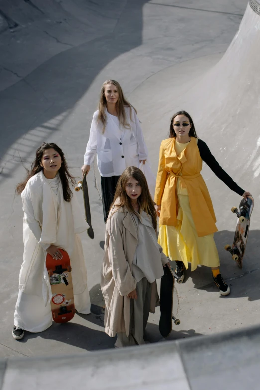 some women with skateboards standing by a ramp