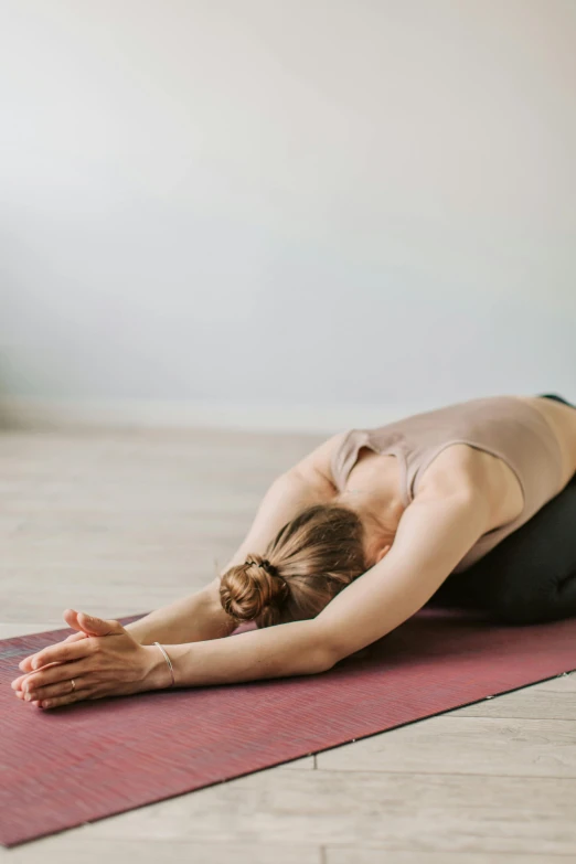 a woman in a yoga outfit is doing a downward pose