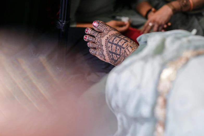 a pair of hands with henna on them