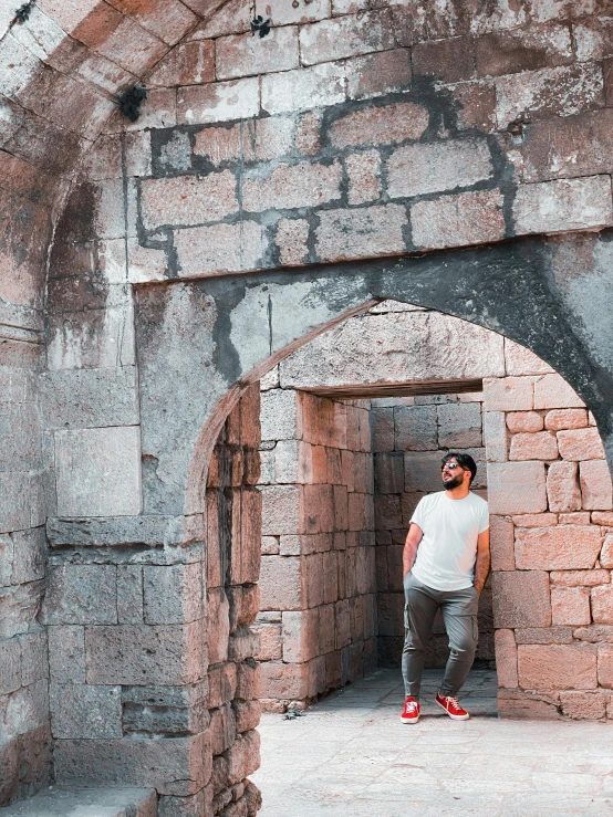a man stands in an old tunnel