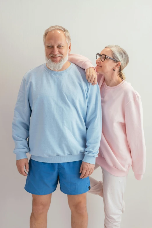 the older man and woman are standing next to each other