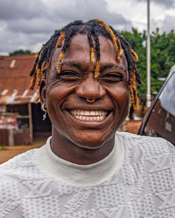 a man with yellow streaks on his face and a smiling