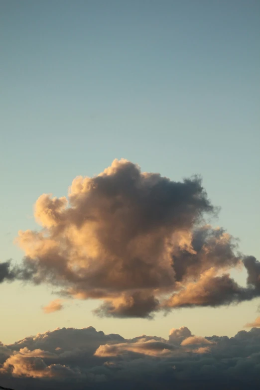 large white cloud on the horizon as it peeks into the dark sky