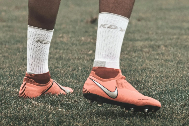 the soccer player wears a pair of nike's new shoes