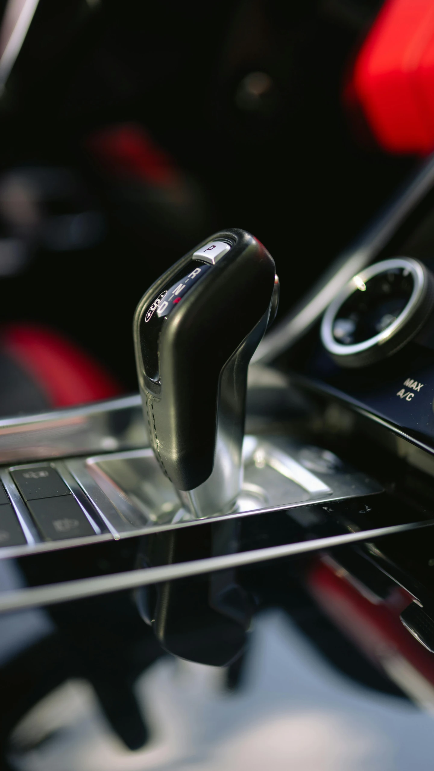 a close up of a car dashboard with two smartphones sitting on the car console