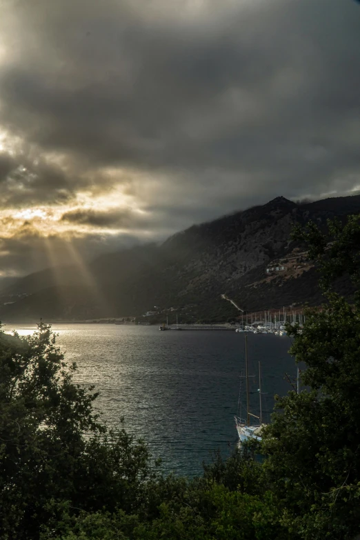 the sun is shining down on boats and trees