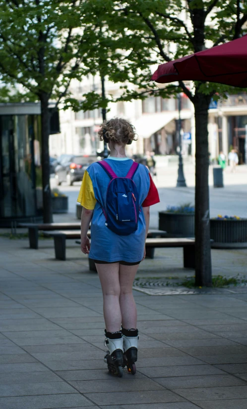 a  in roller skates on a sidewalk