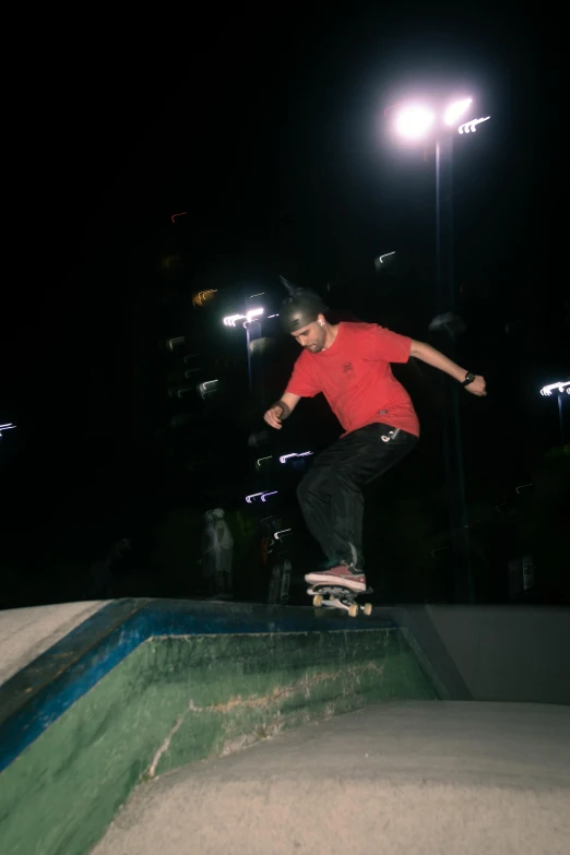 a person is skateboarding on a rail at night