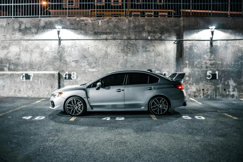 a car parked in a parking spot with lights on