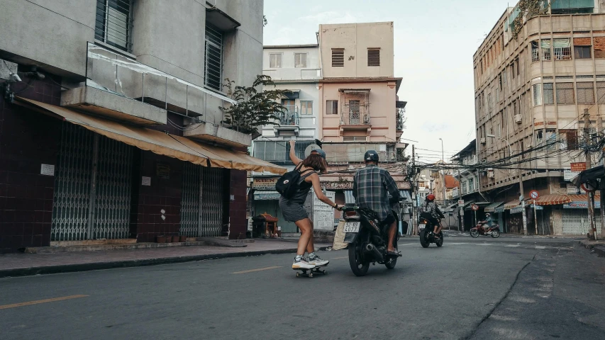 a person riding on the skate board down the road