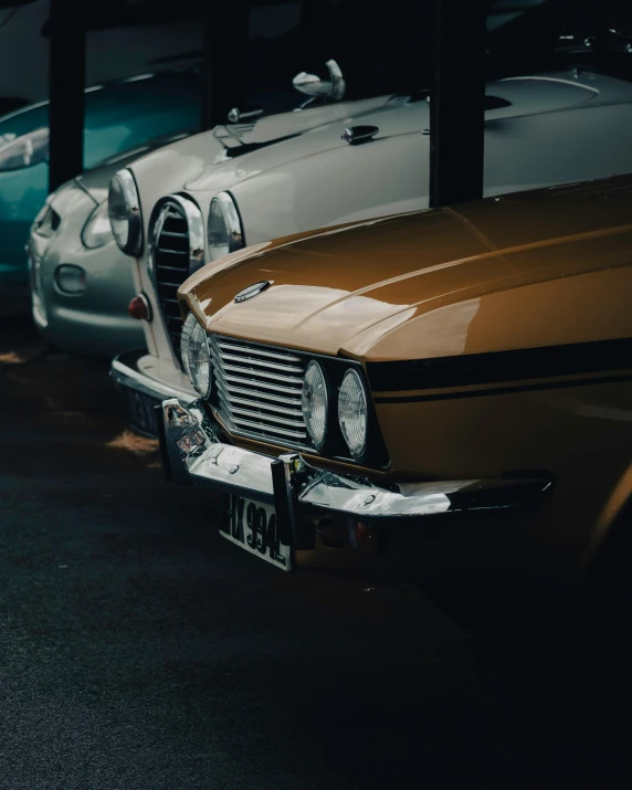 a row of classic cars parked side by side