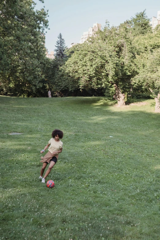 a  is sitting on a soccer ball in a field