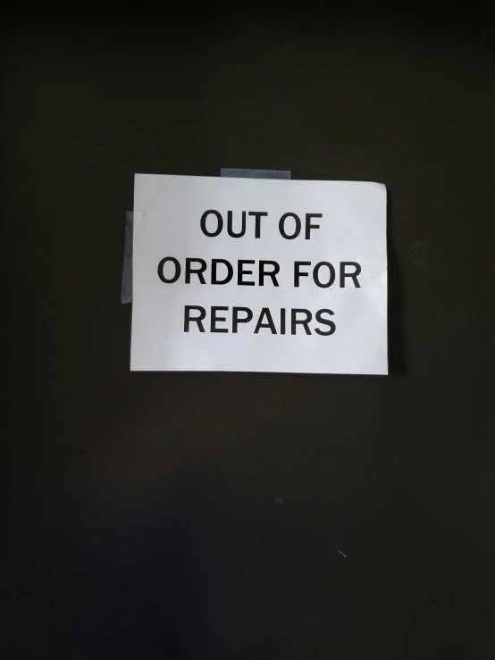 the notice of a repair job posted to a refrigerator