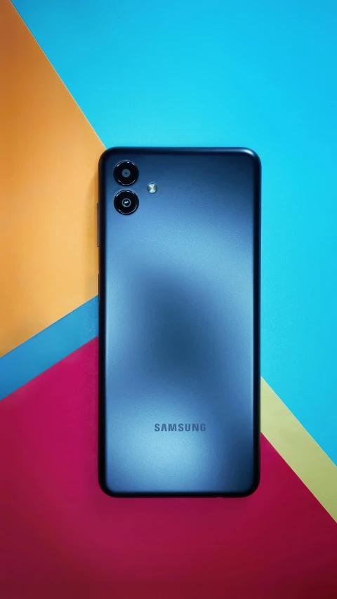 an ultra phone laying on top of colorful background