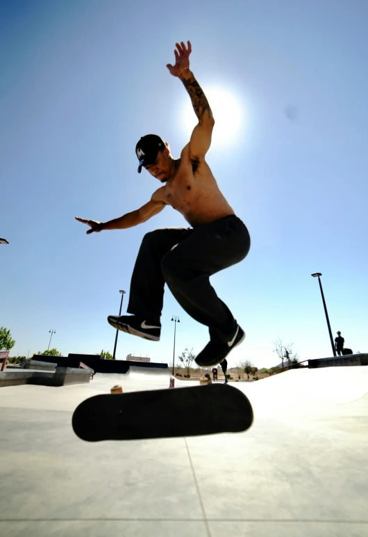 a man riding a skateboard in the air near a parking lot