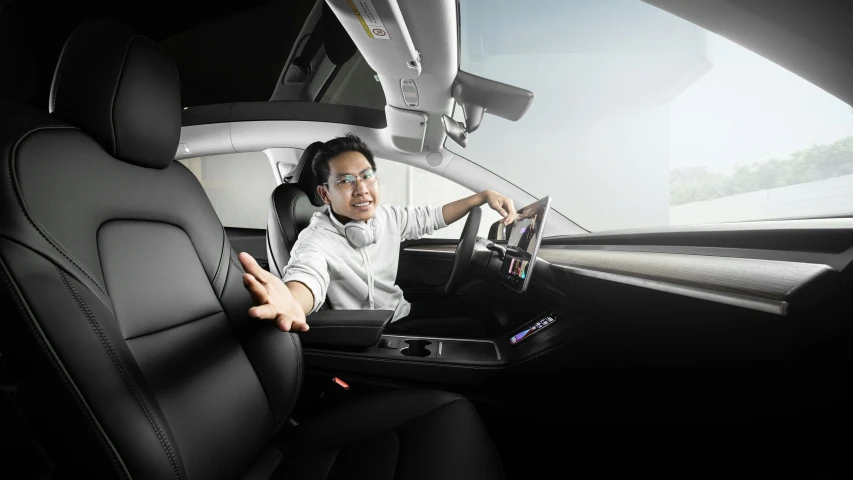 a woman using a laptop sitting in a vehicle