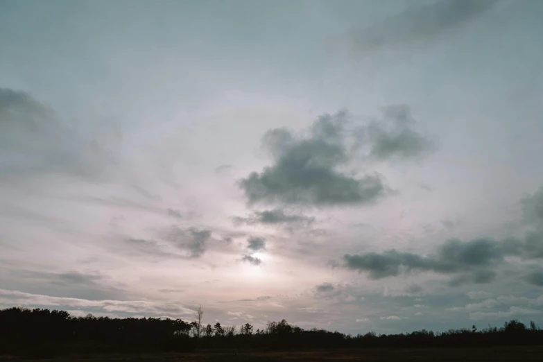 a lone bench is in front of the beautiful sky