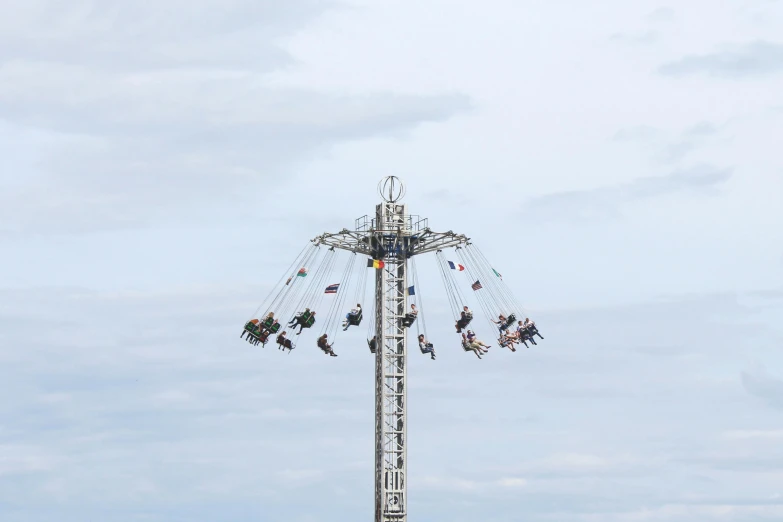 a carnival ride set up with many riders on it