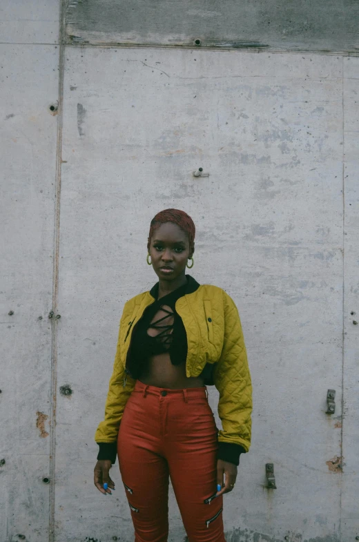 a woman in yellow jacket and red pants