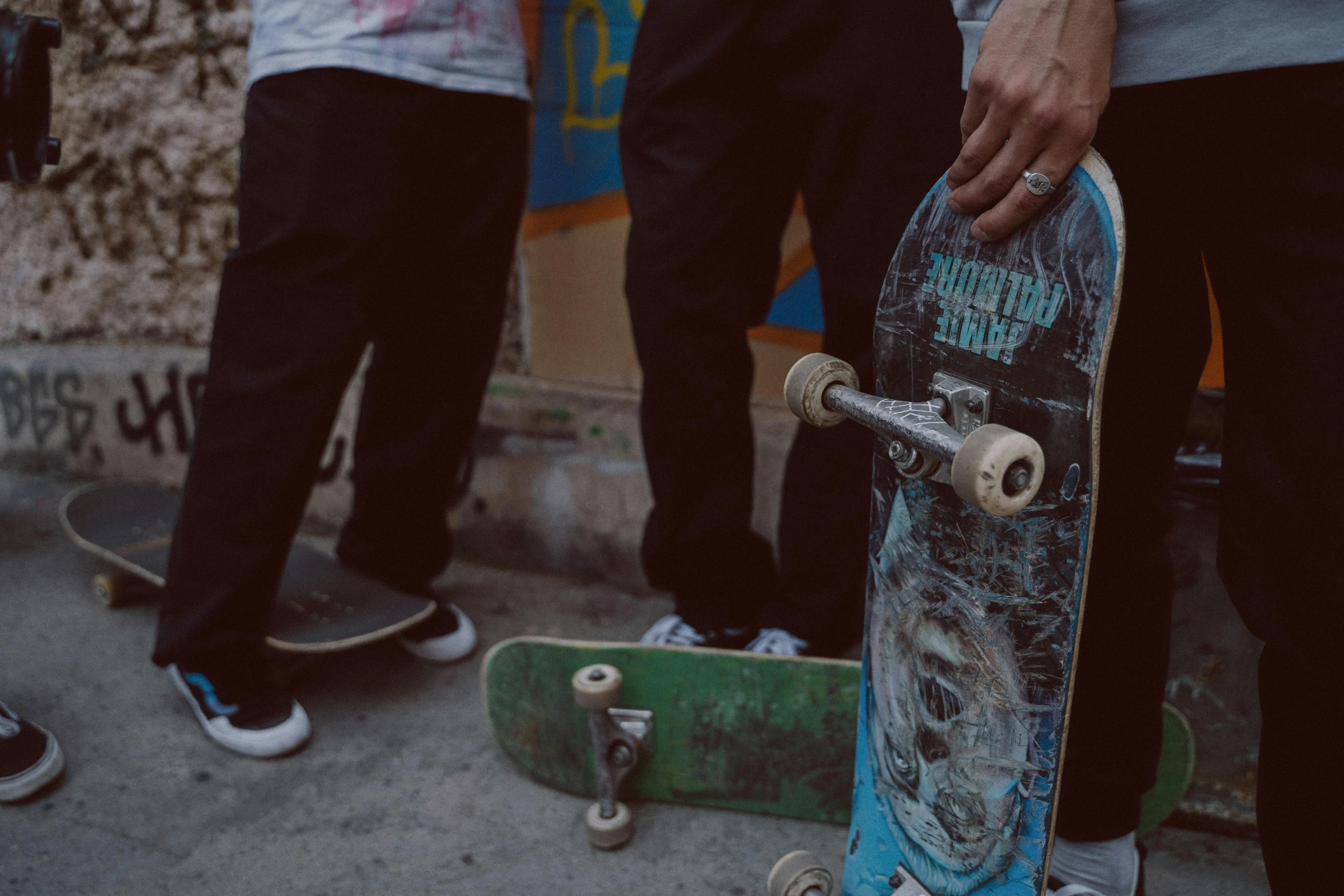 several people with their feet on skateboards near one another