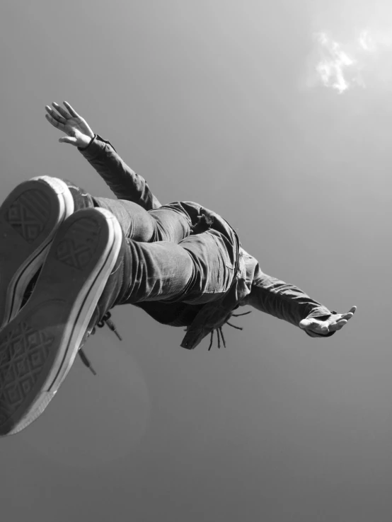 a person flies in the air while wearing sneakers