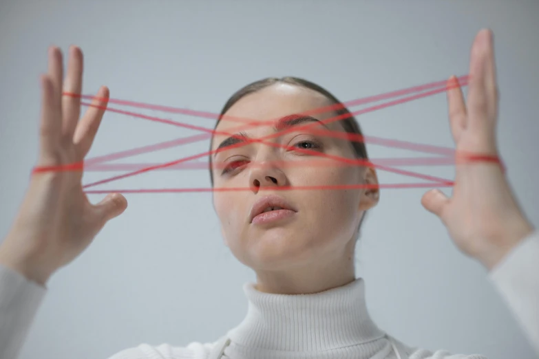 a woman using her hands to create lines over the head