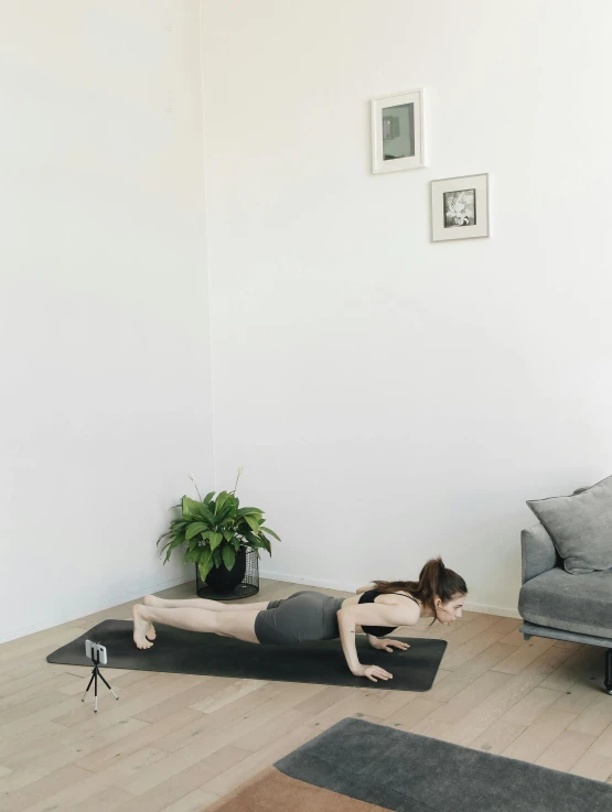 a woman practicing yoga while lying on her back in a studio