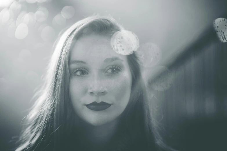 a woman in a black and white po looks at the camera