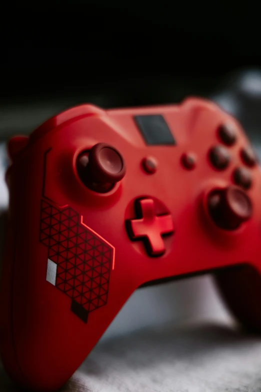 red and black controller with small logo sitting on table