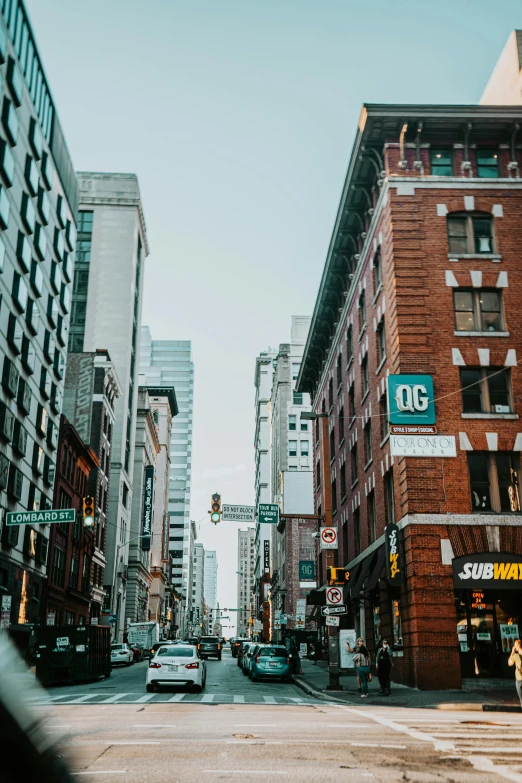 a busy city street filled with traffic and tall buildings