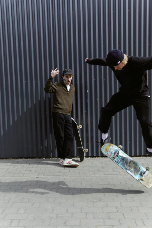 two people jumping and one on a skateboard
