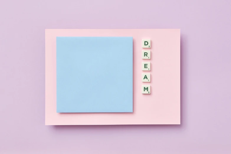 a blue and pink colored notepad with small letters on it