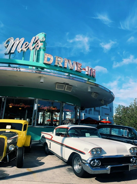 several classic cars parked next to each other in front of a casino