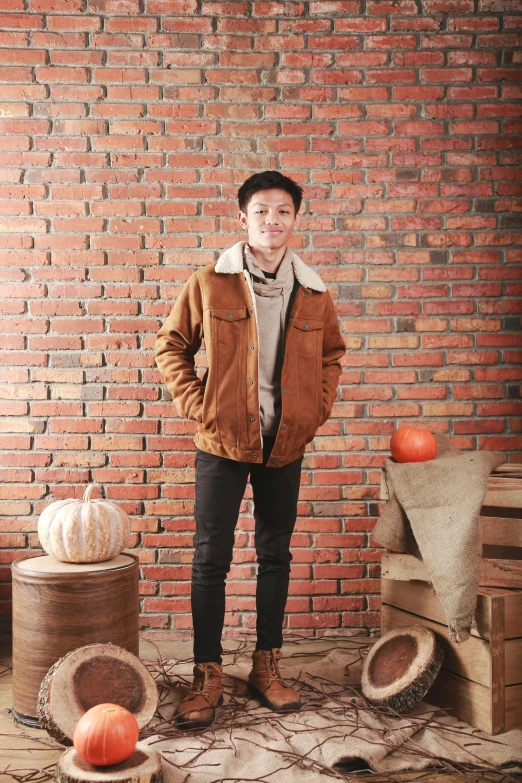 a young man standing next to several carved pumpkins