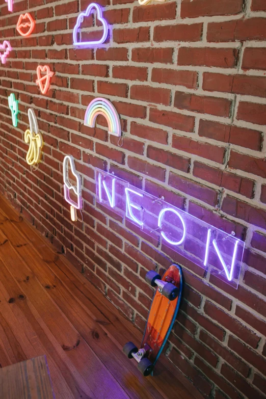 an orange skateboard leaning against a brick wall with neon signs on it