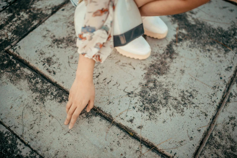 a person sitting down while touching their toe