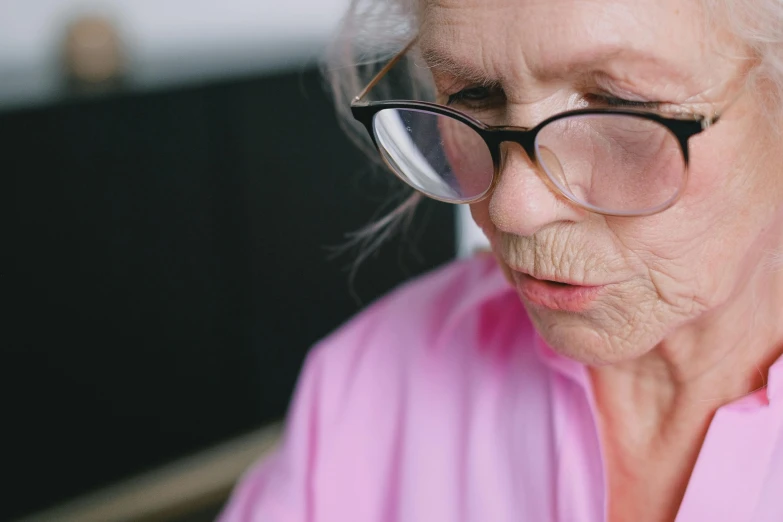 an old lady in glasses with her eyes closed