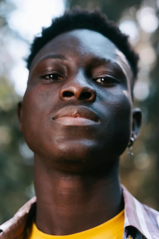 an african american man wearing a striped shirt