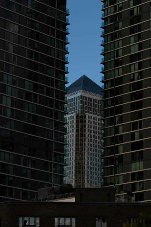 a large building towering over a city in the day