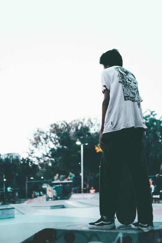 a man riding a skateboard on the top of a ramp