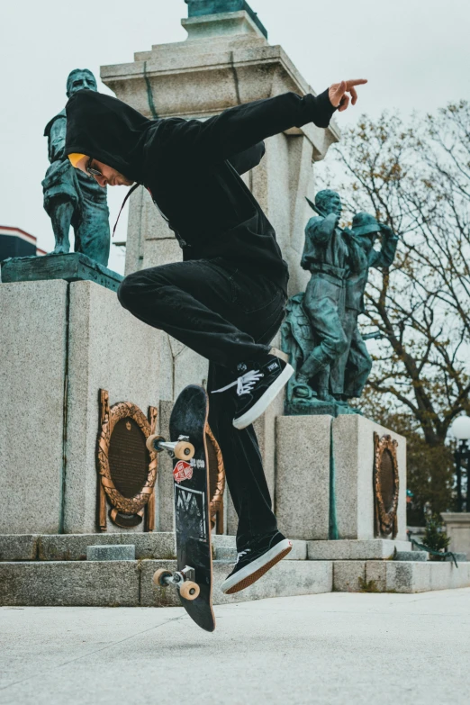 a person on a skateboard is jumping over some statues