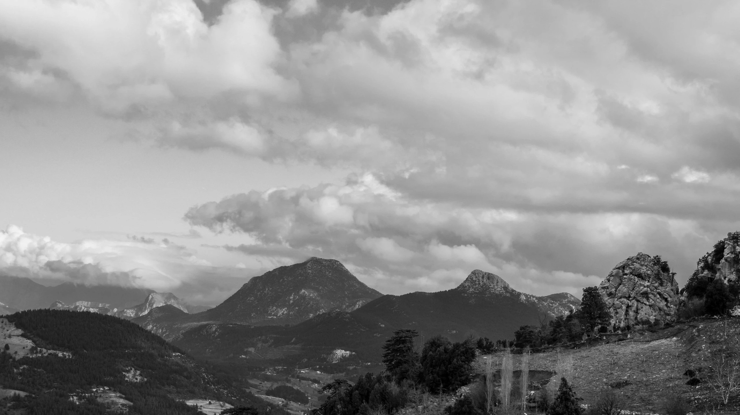 mountains are shown with clouds in the background