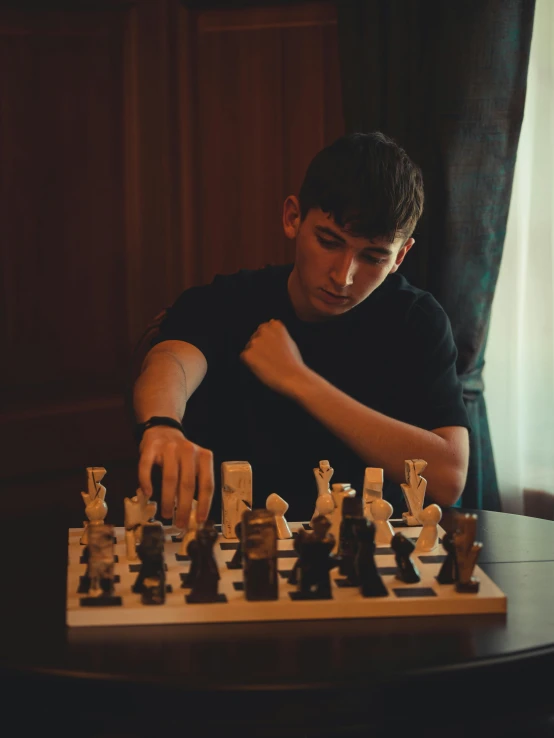 a man is playing chess on the table