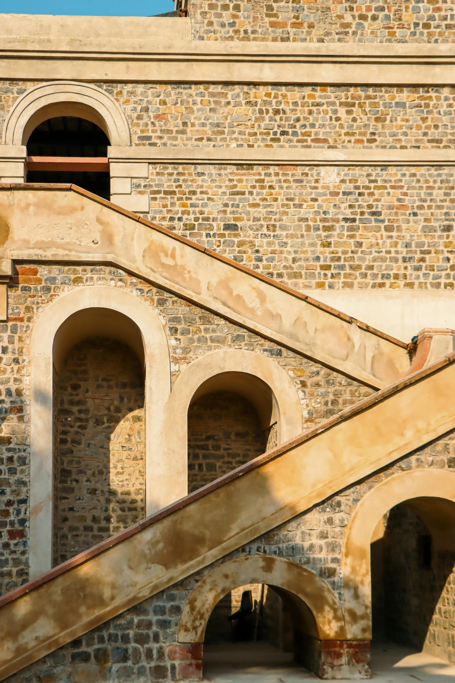 an old stone building with a staircase going up to it