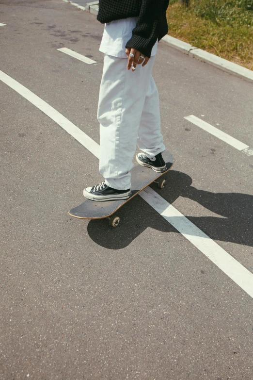 a man riding a skateboard down a street