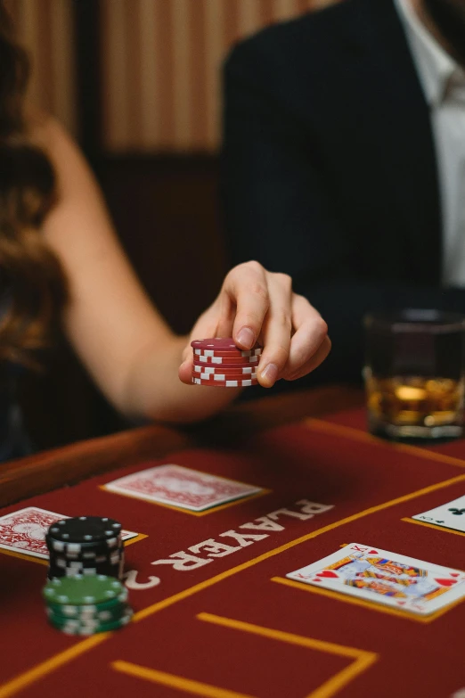 the person is playing cards on a table