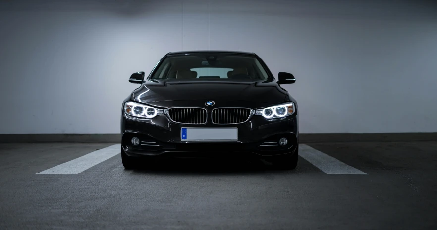 a parked black car sitting in a parking space