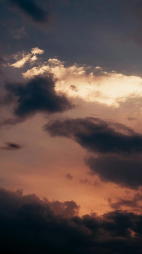 the sky at sunset with clouds in the background